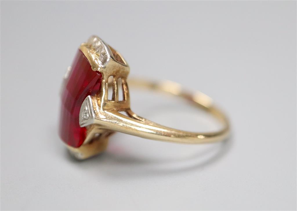 A 1950s? 10k yellow metal and fancy cut synthetic? ruby and diamond chip set dress ring, size L/M, gross 3.5 grams.